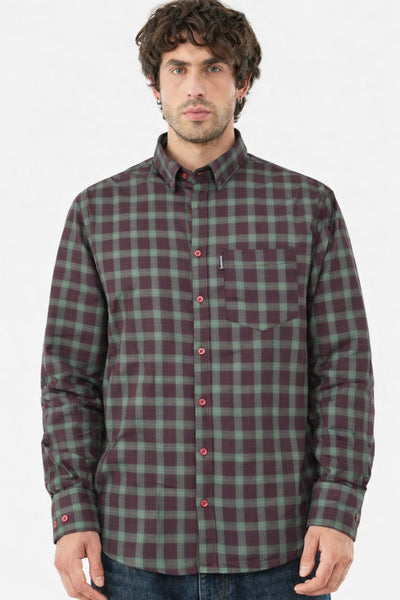 Man wearing a green and red plaid shirt on a white background