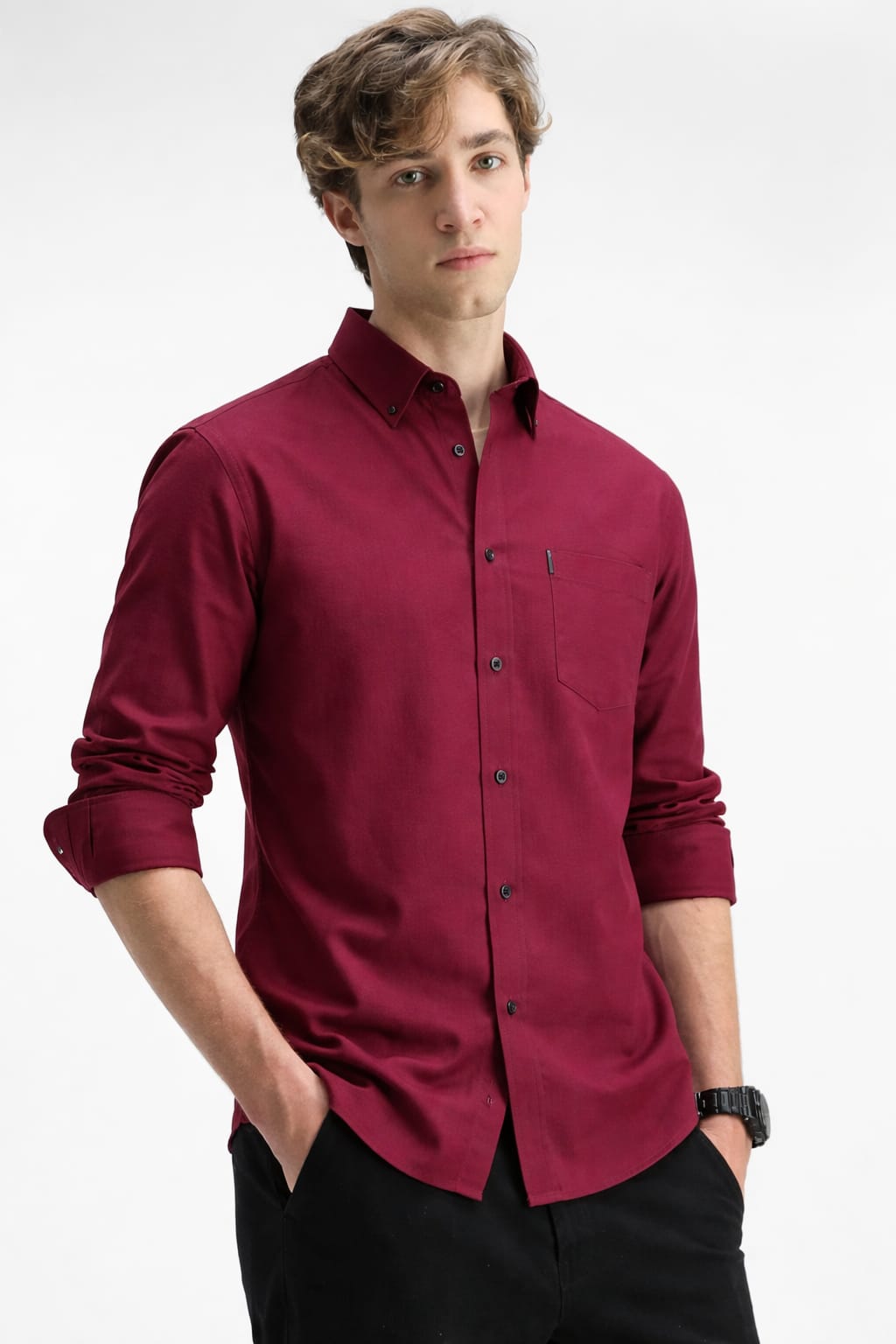 Man wearing a maroon button-up shirt on a white background