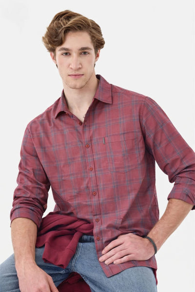 Man wearing a red plaid shirt against a white background