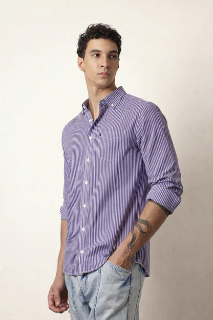 Man wearing a purple striped shirt against a plain background