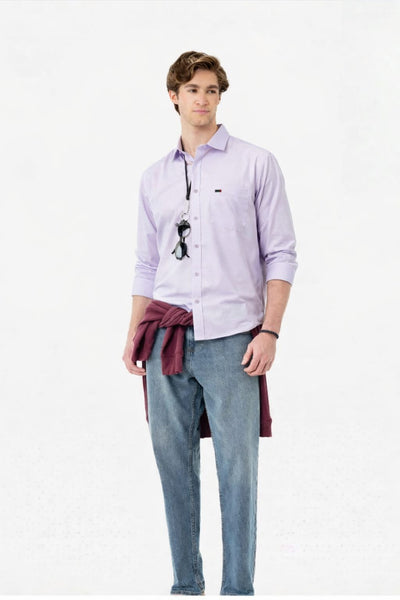 Person wearing a light purple shirt with a dark tie and light blue jeans on a white background