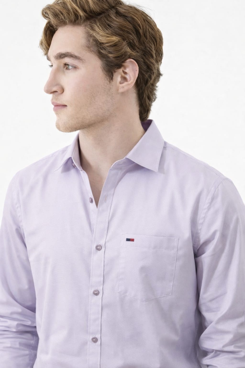 Man wearing a light purple dress shirt with a visible brand logo on a white background