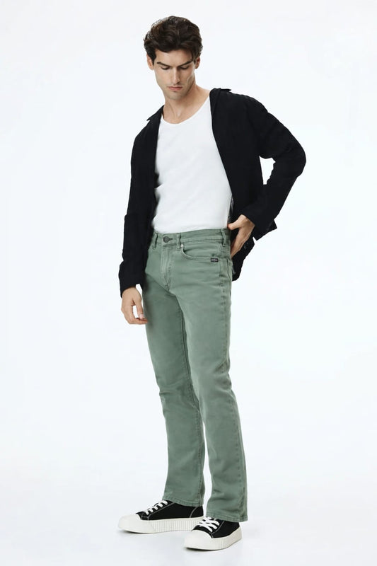 Man wearing a black cardigan, white shirt, green pants, and black sneakers on a white background