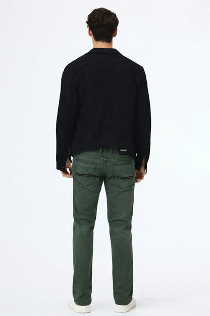 Person wearing a black shirt and green pants on a white background