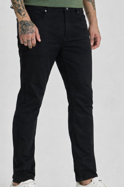 Person wearing black jeans on a white background