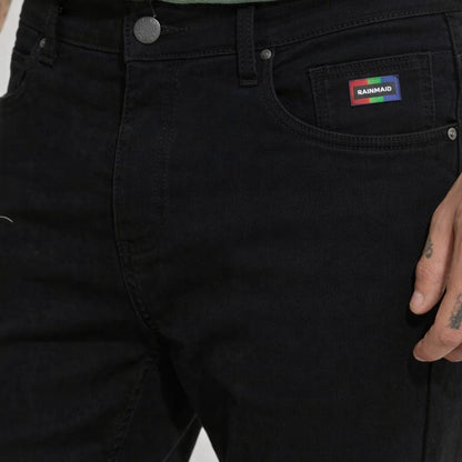 Black pants with a brand logo on the pocket against a neutral background