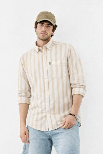 Man wearing a striped shirt and cap on a white background