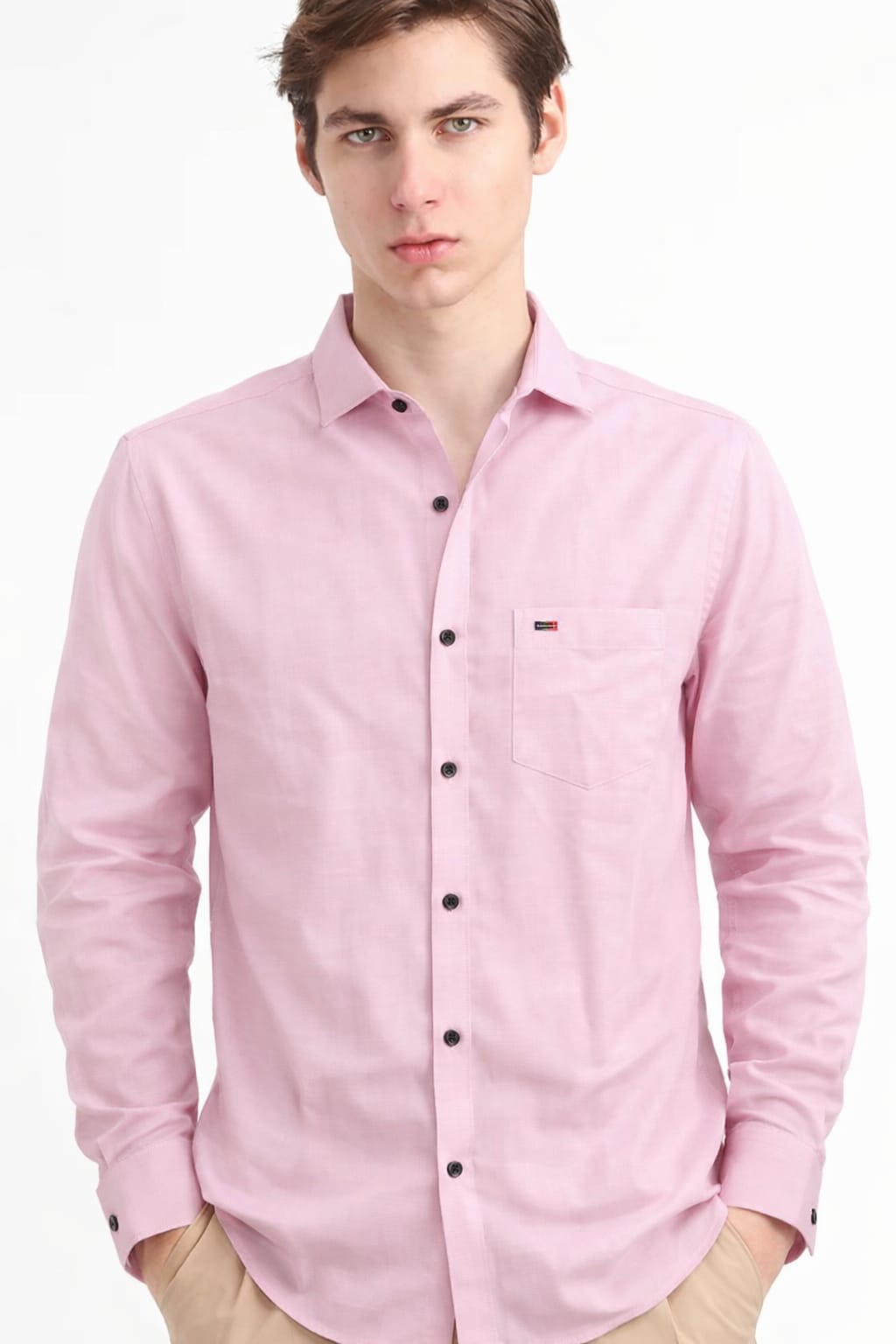 Man wearing a pink button-up shirt with a brand logo on a white background