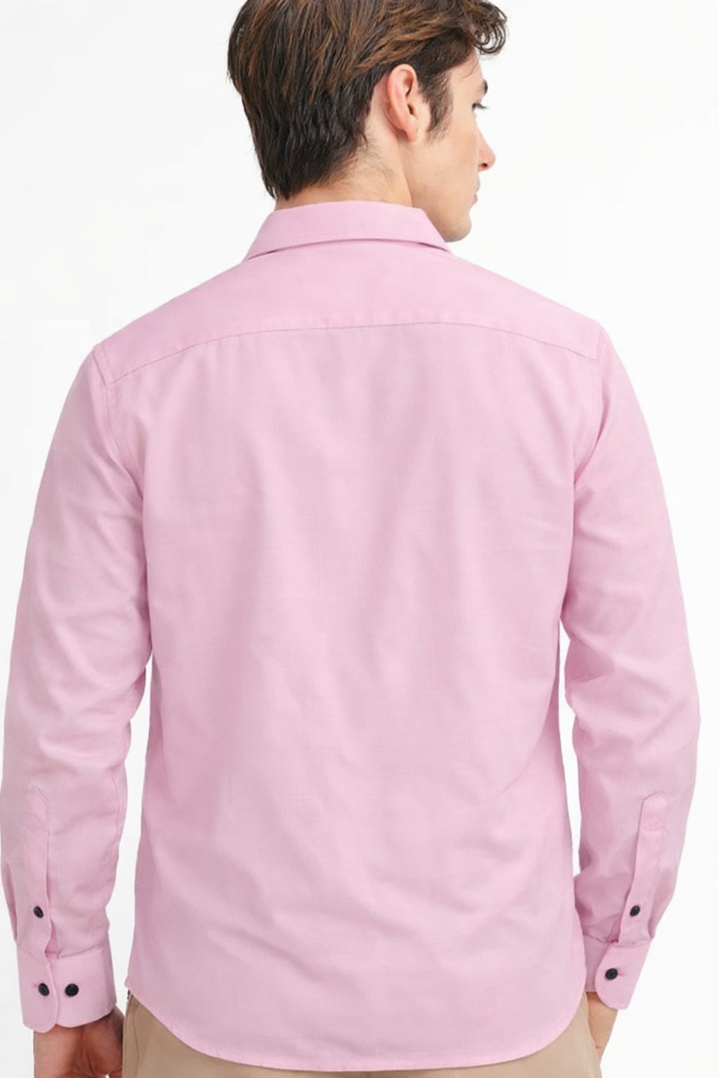 Person wearing a pink shirt with a white background