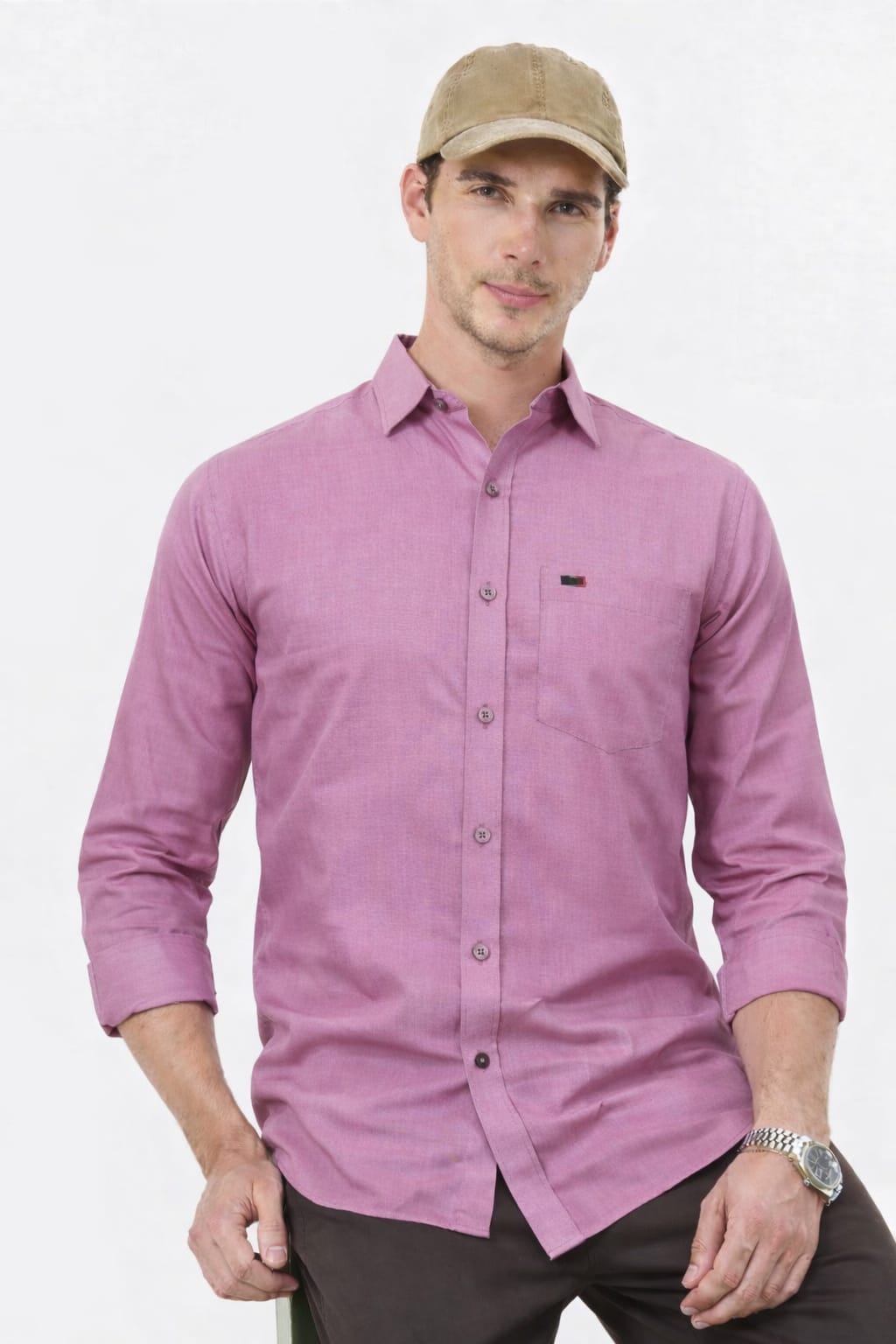 Man wearing a purple button-up shirt and beige cap on a white background
