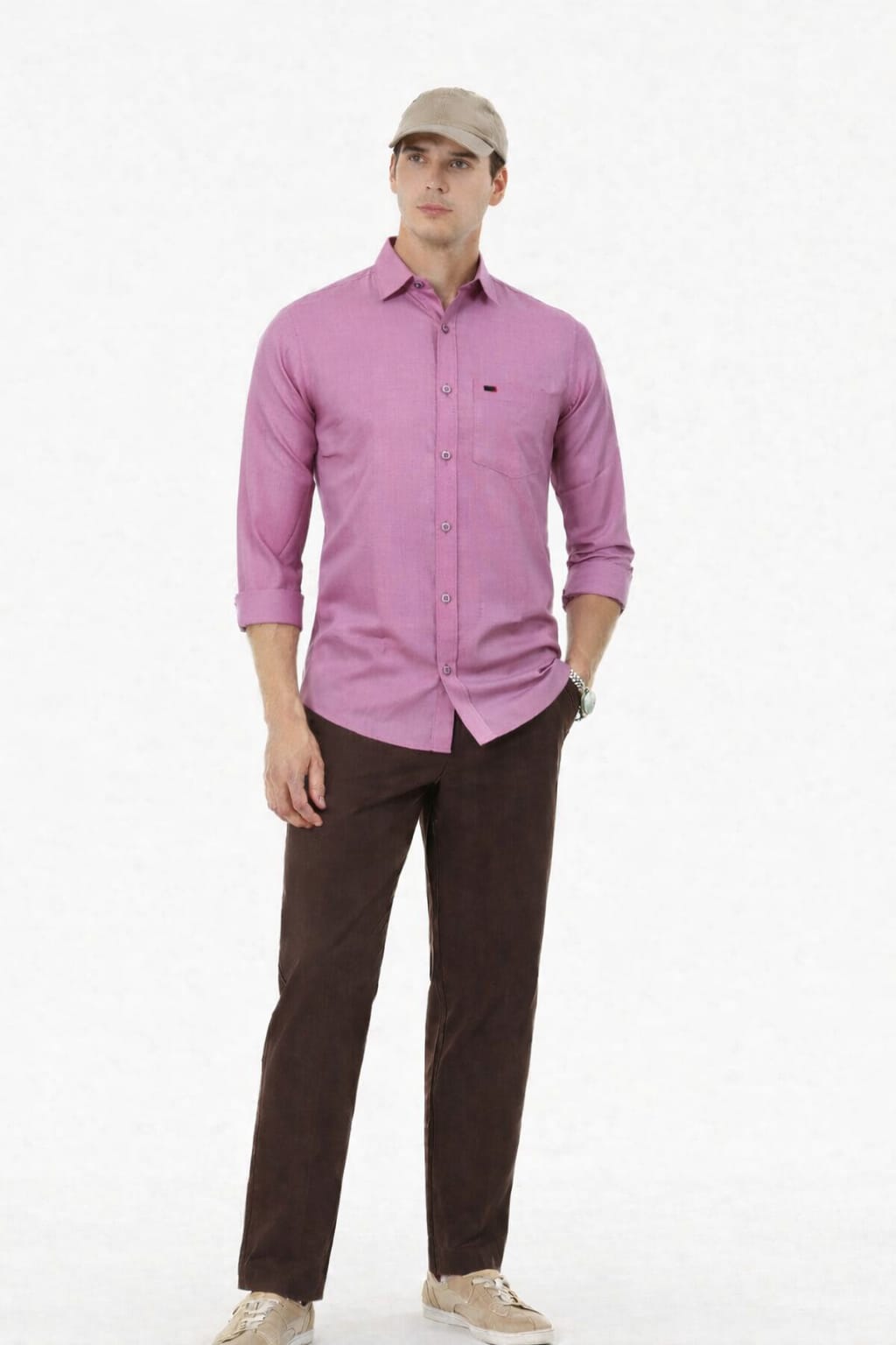 Man wearing a pink shirt and brown pants on a white background