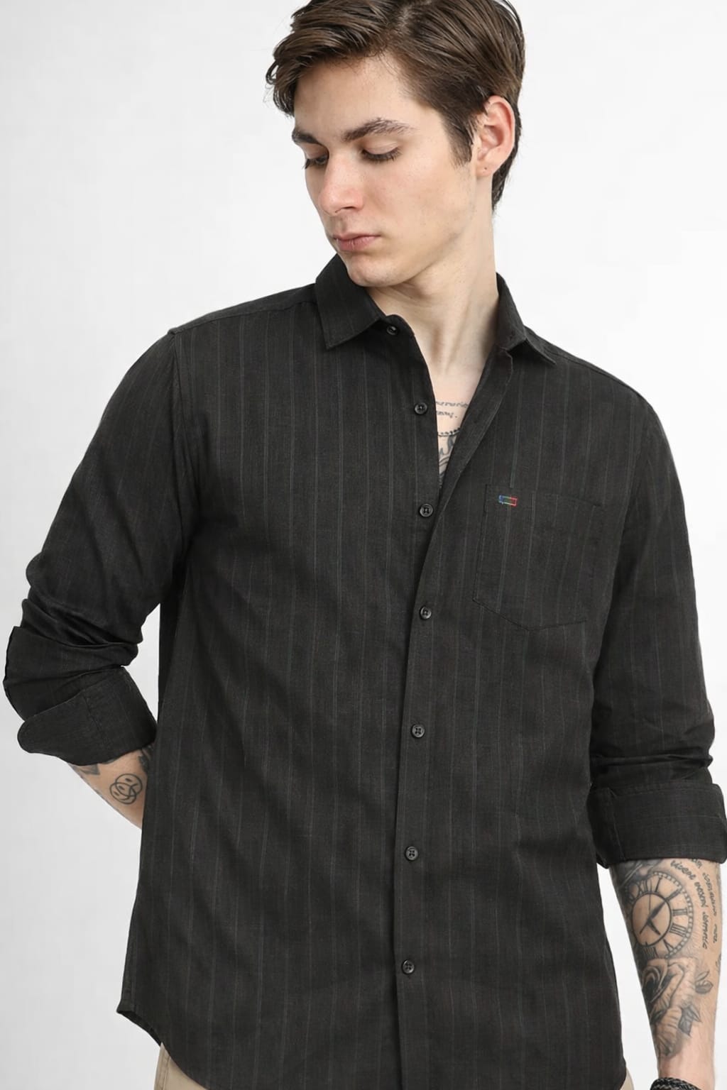 Person wearing a black textured shirt on a white background