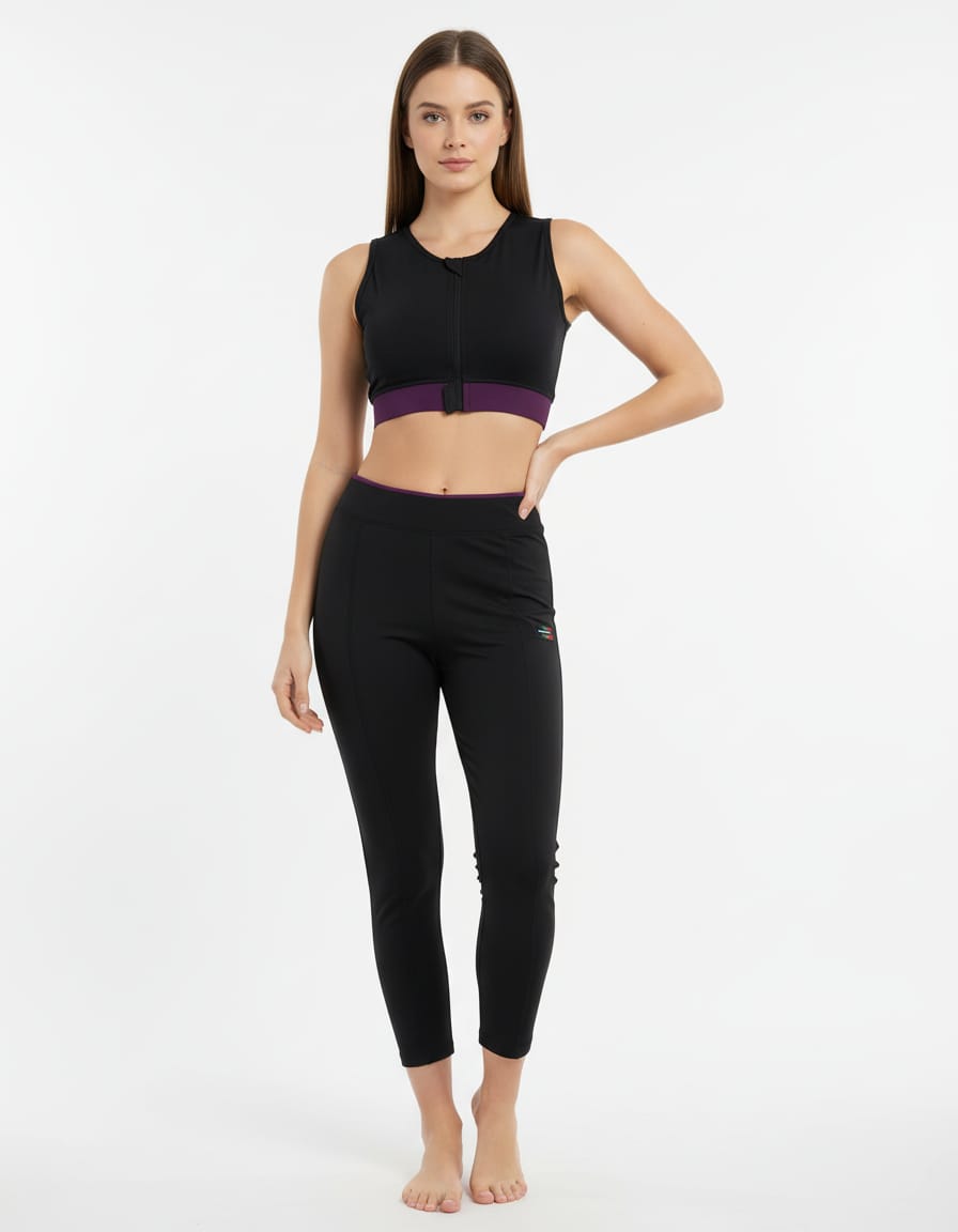 Woman wearing a black athletic outfit with a purple accent on a white background