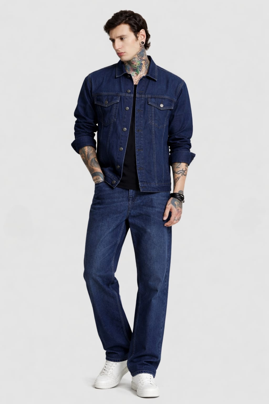 Man wearing a blue denim jacket and jeans on a white background
