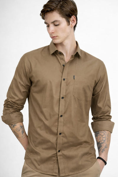 Man wearing a brown button-up shirt on a white background