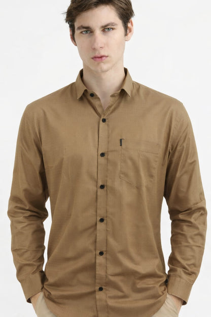 Man wearing a brown button-up shirt on a white background