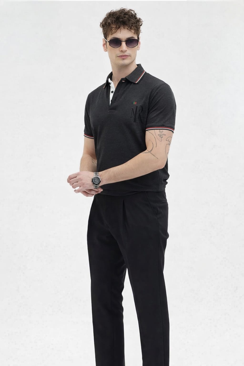 Man wearing a black polo shirt and pants on a white background