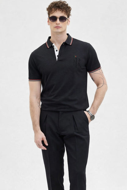 Man wearing a black polo shirt and black pants on a white background