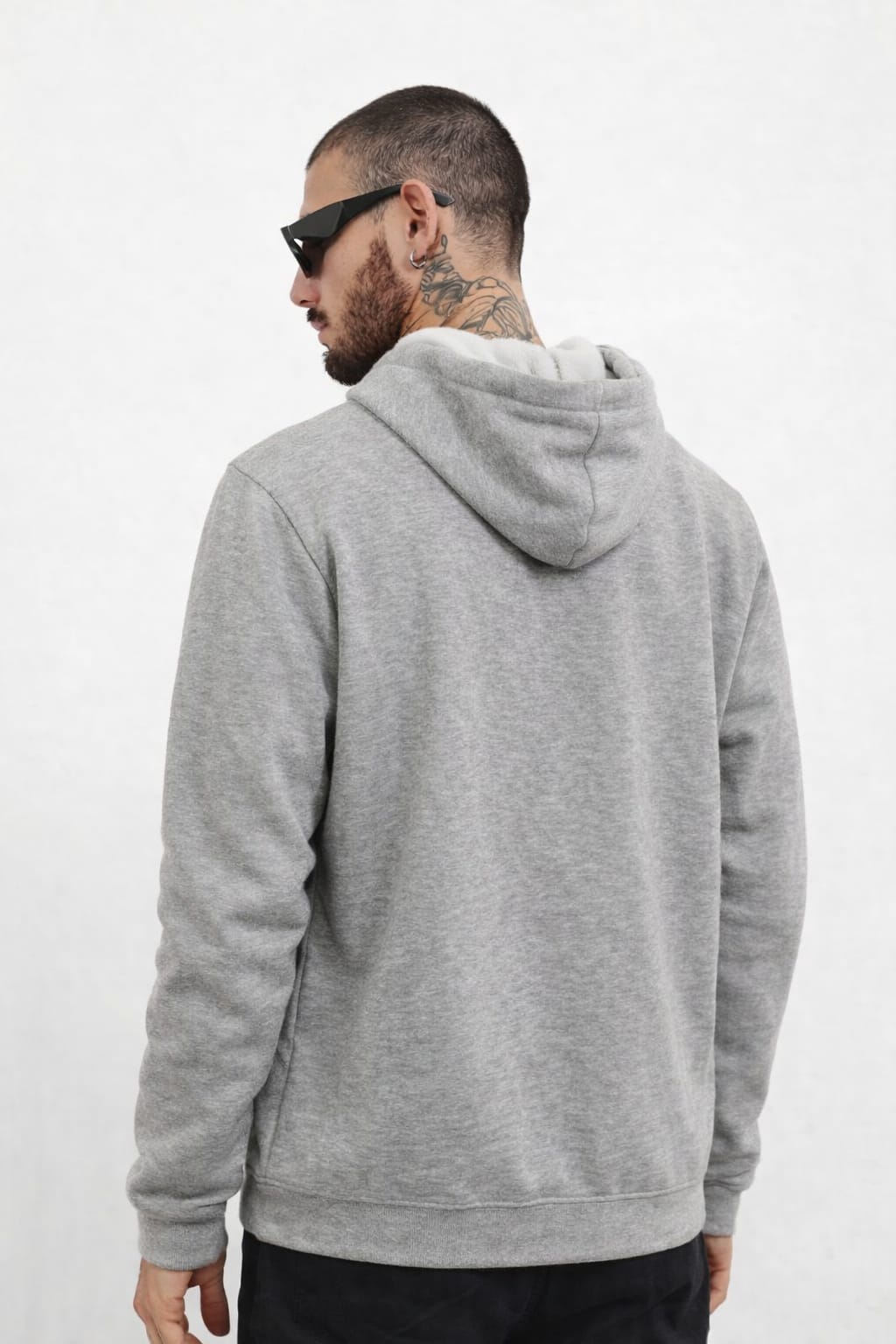 Man wearing a gray hoodie from behind on a white background