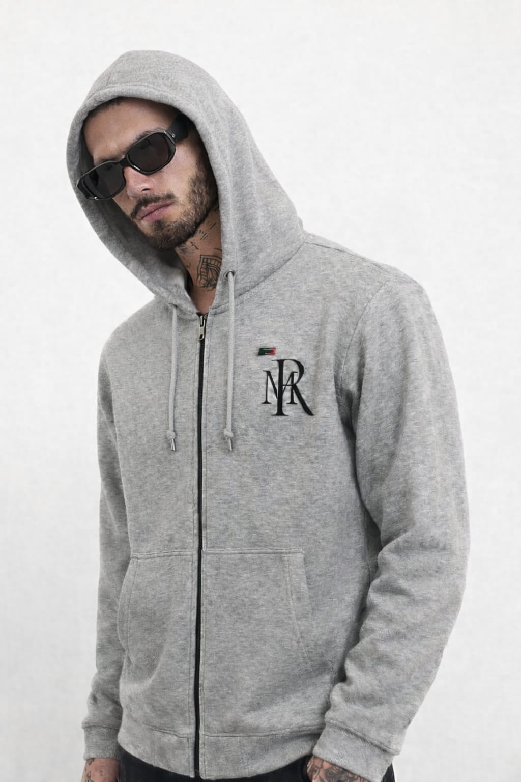 Person wearing a gray hoodie with a logo on a white background