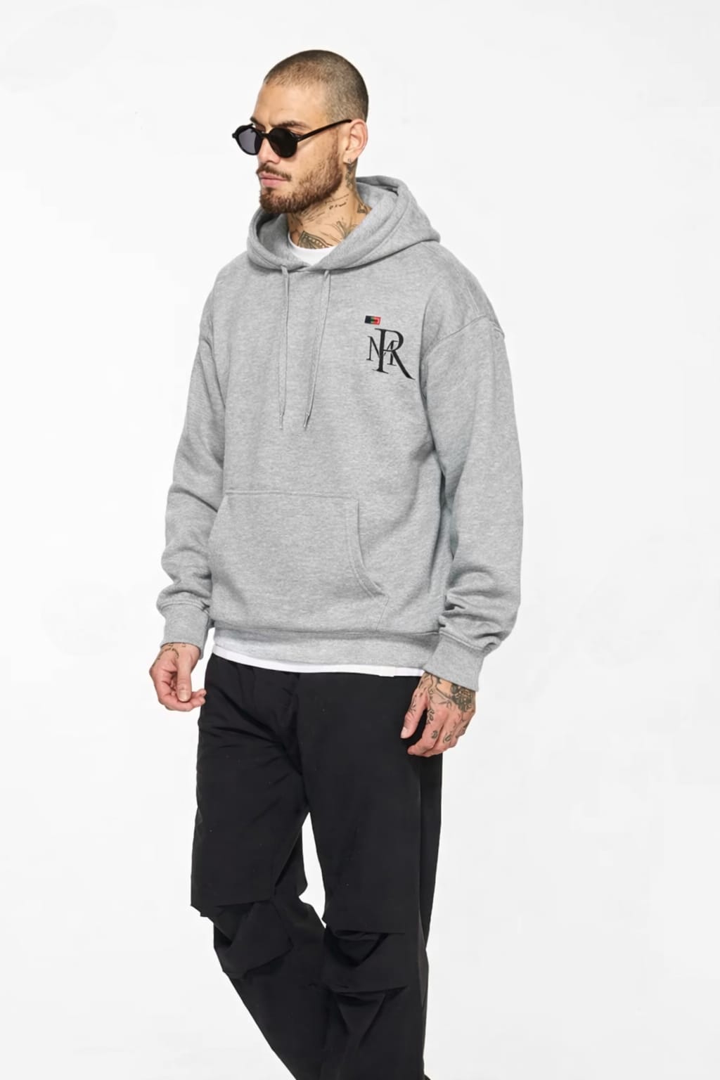 Man wearing a gray hoodie with a logo on a white background
