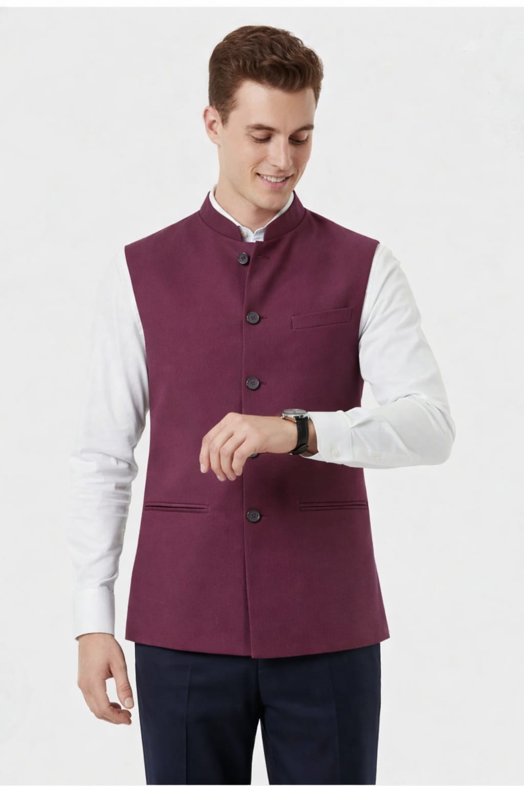 Man wearing a maroon vest over a white shirt on a white background