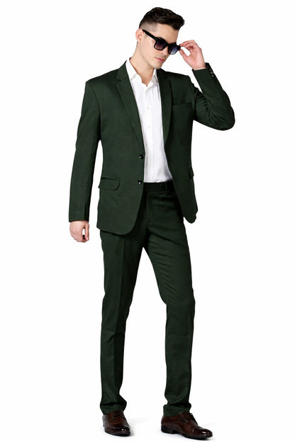 Man wearing a green suit and sunglasses on a white background