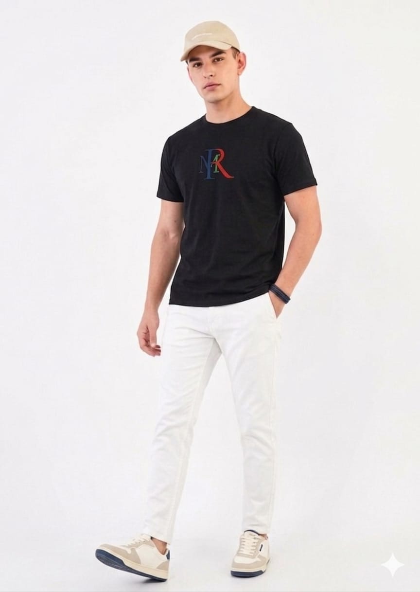 Man wearing a black t-shirt with a logo and white pants on a white background