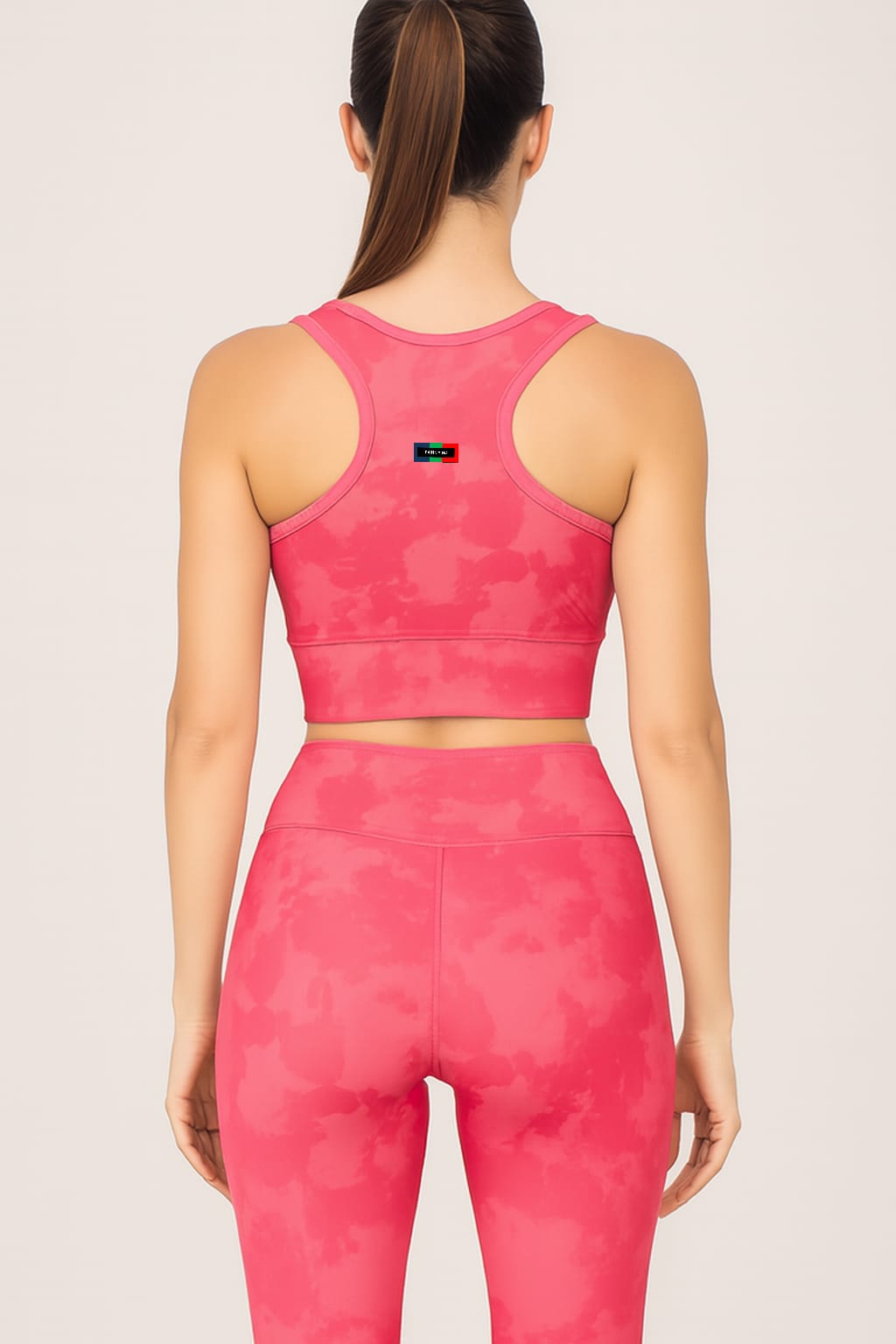 Person wearing a pink camouflage sports outfit on a light gray background