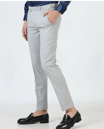 Person wearing light gray pants with a white background
