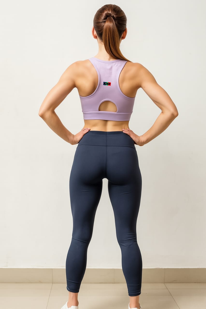 Person wearing a purple sports bra and navy leggings against a white background