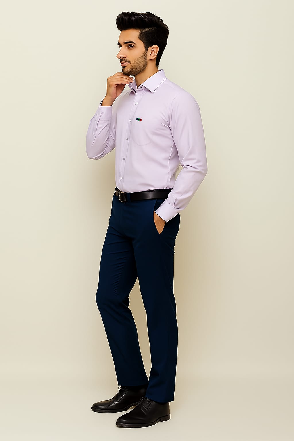 Man wearing a light purple dress shirt, navy pants, and black shoes against a beige background