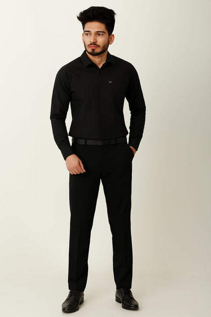 Man wearing a black shirt and pants on a white background