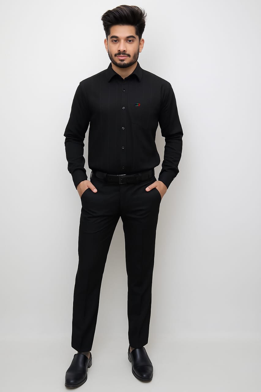 Man wearing a black shirt and pants against a white background