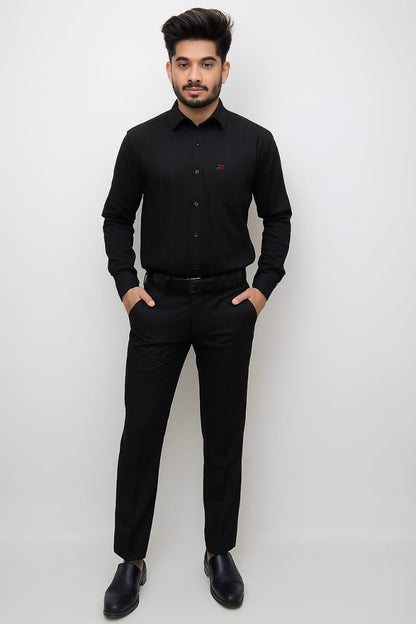 Man wearing a black shirt and pants against a white background