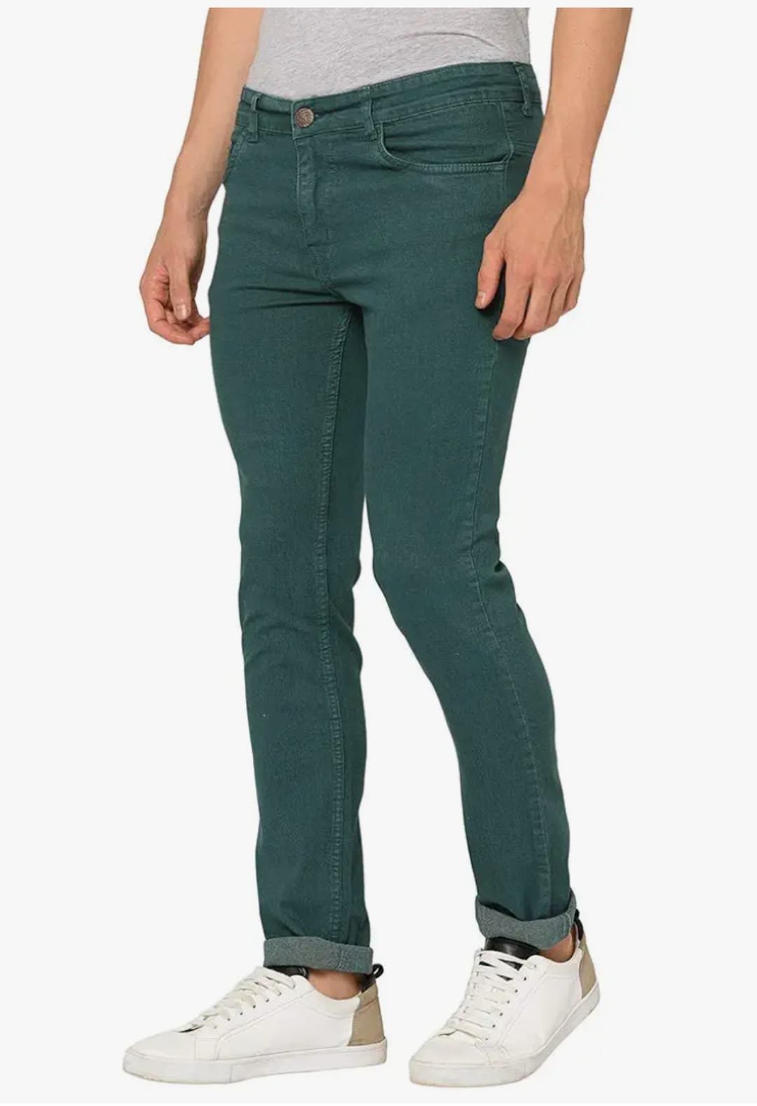 Person wearing teal jeans with a plain white background