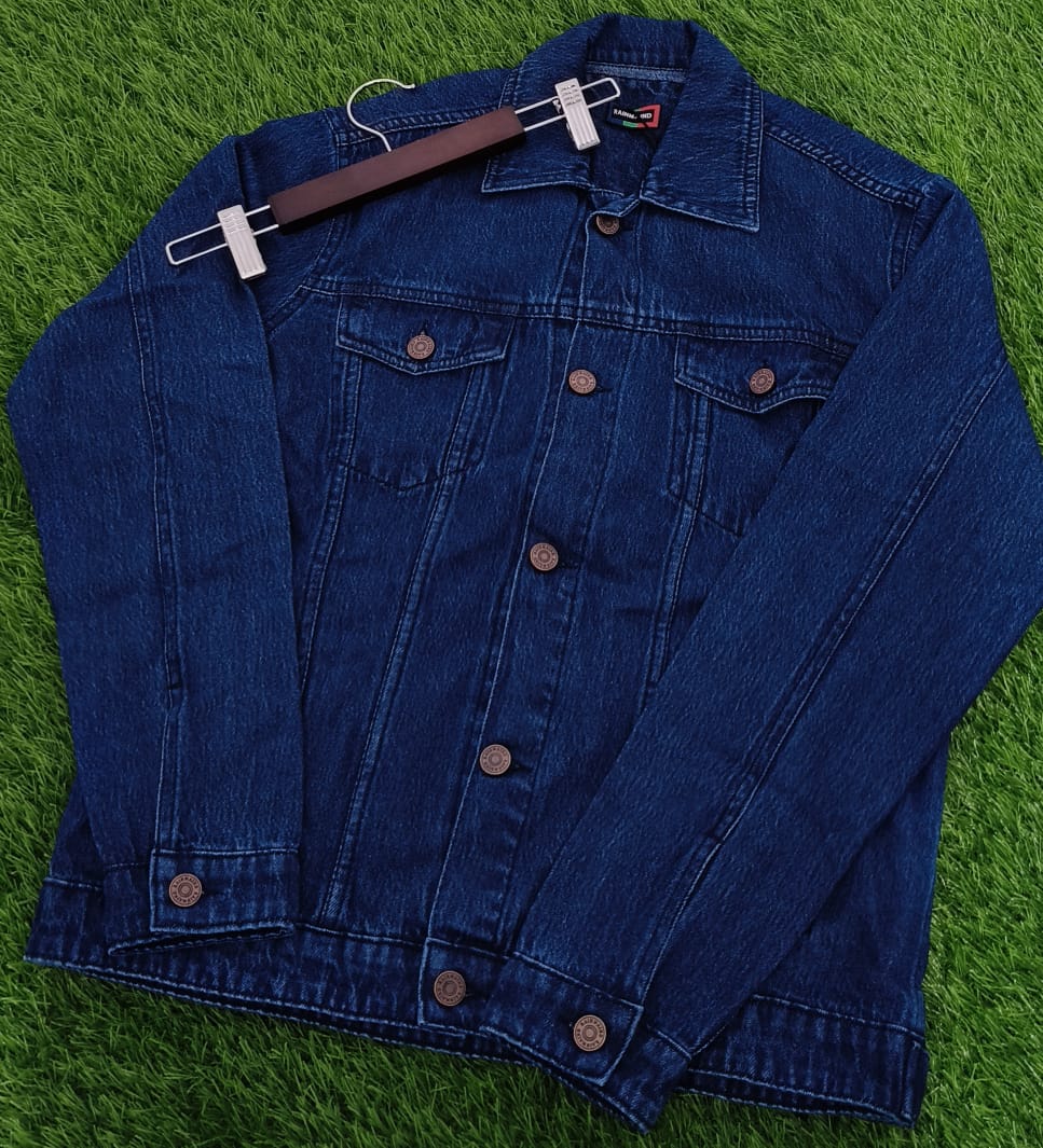 Blue denim jacket on a hanger against a green grass background