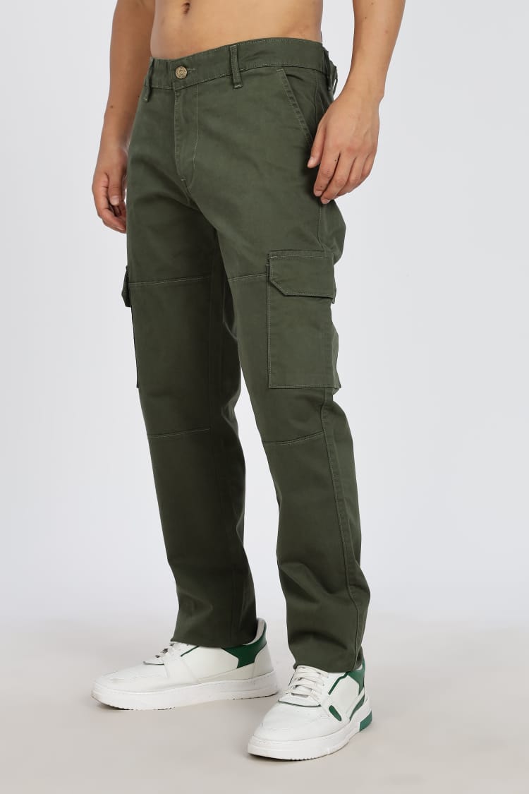 Person wearing green cargo pants on a white background