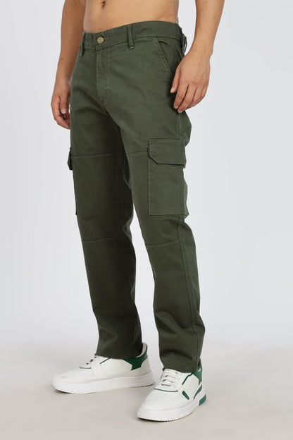 Person wearing green cargo pants on a white background