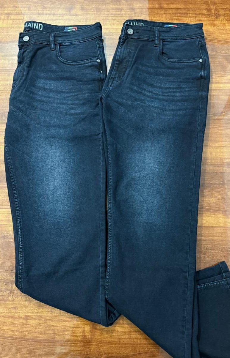 Pair of blue jeans on a wooden surface



