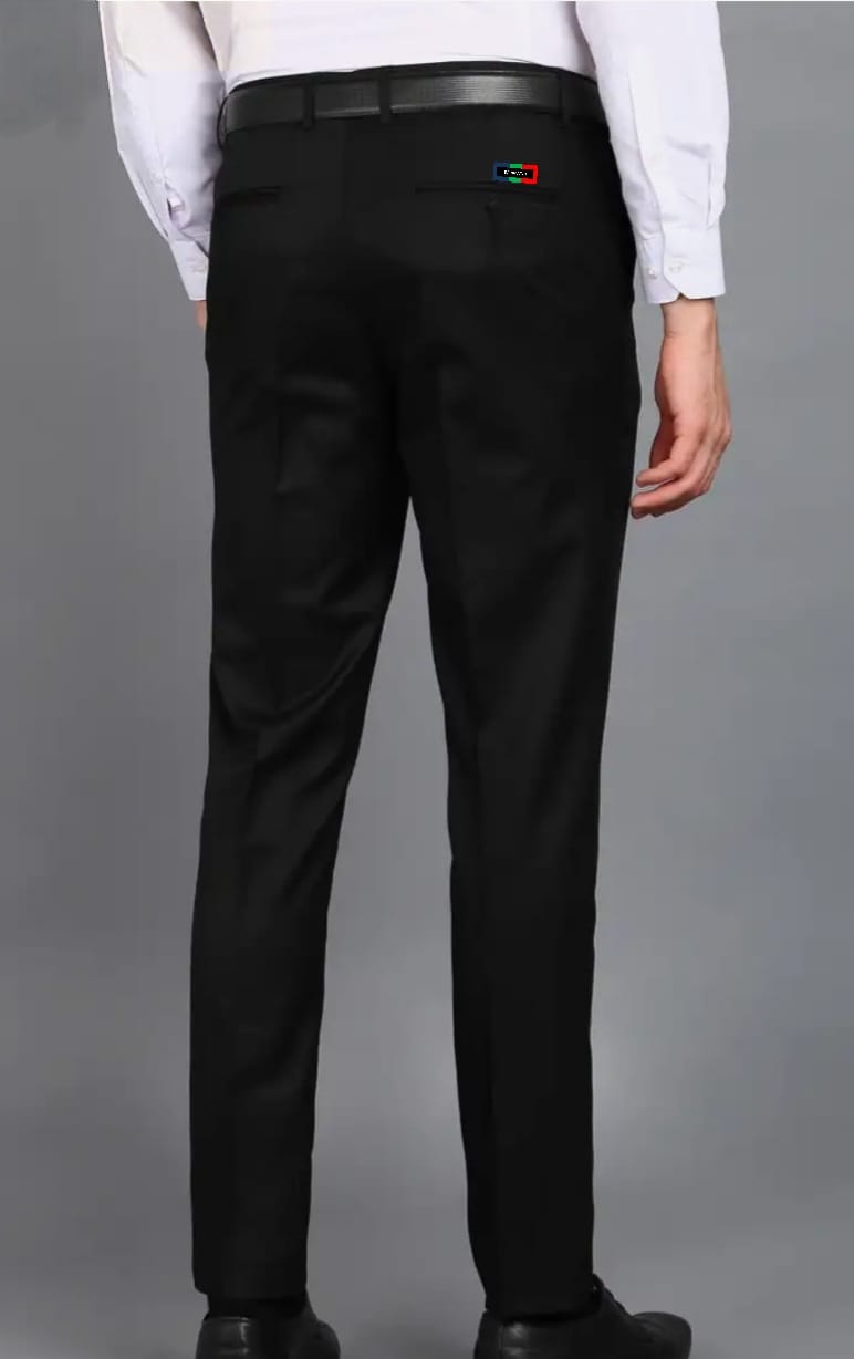 Black pants with a logo on the back pocket against a gray background