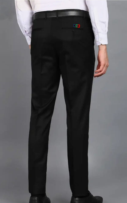 Black pants with a logo on the back pocket against a gray background