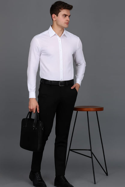 Man wearing a white dress shirt and black pants holding a black briefcase against a gray background