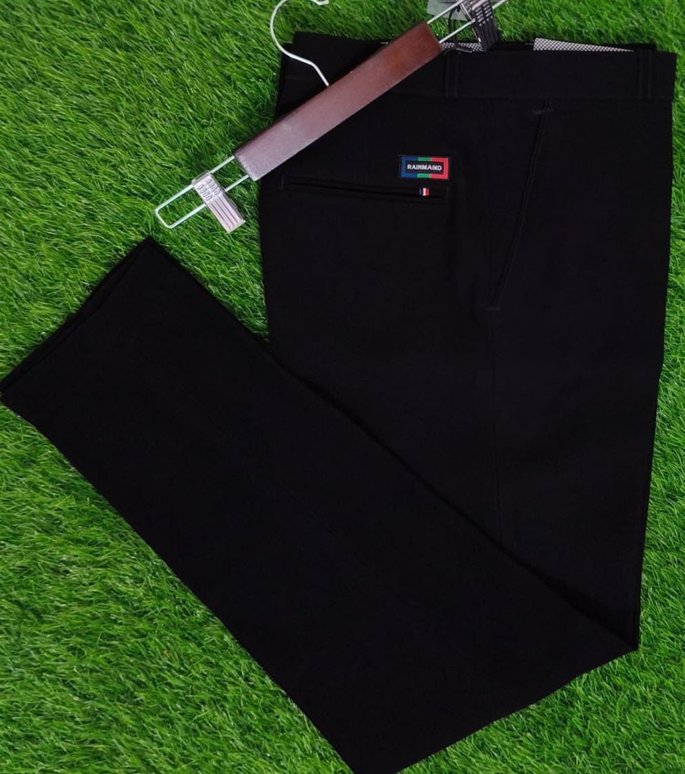 Black pants with a brand label on a green grass background