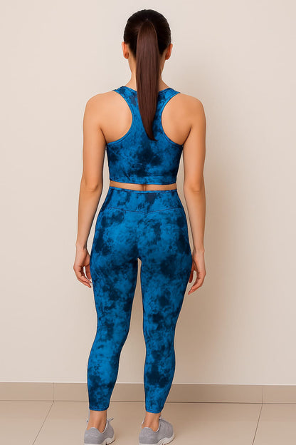 Woman wearing a blue tie-dye athletic outfit against a beige background