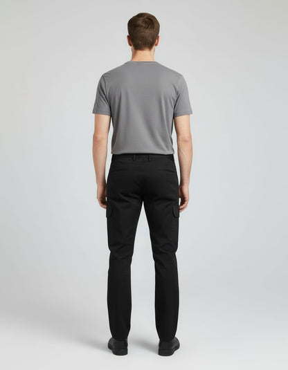 Man wearing a gray t-shirt and black pants on a white background