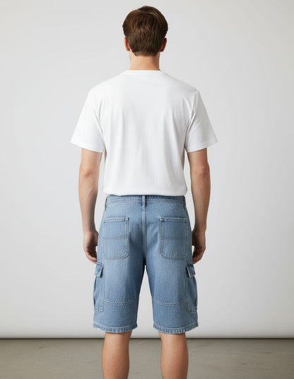 Person wearing a white t-shirt and blue cargo shorts against a plain background