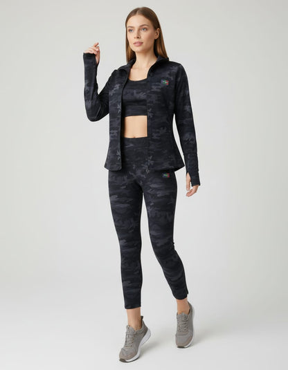 Woman wearing a black tie-dye outfit with a jacket and pants on a white background