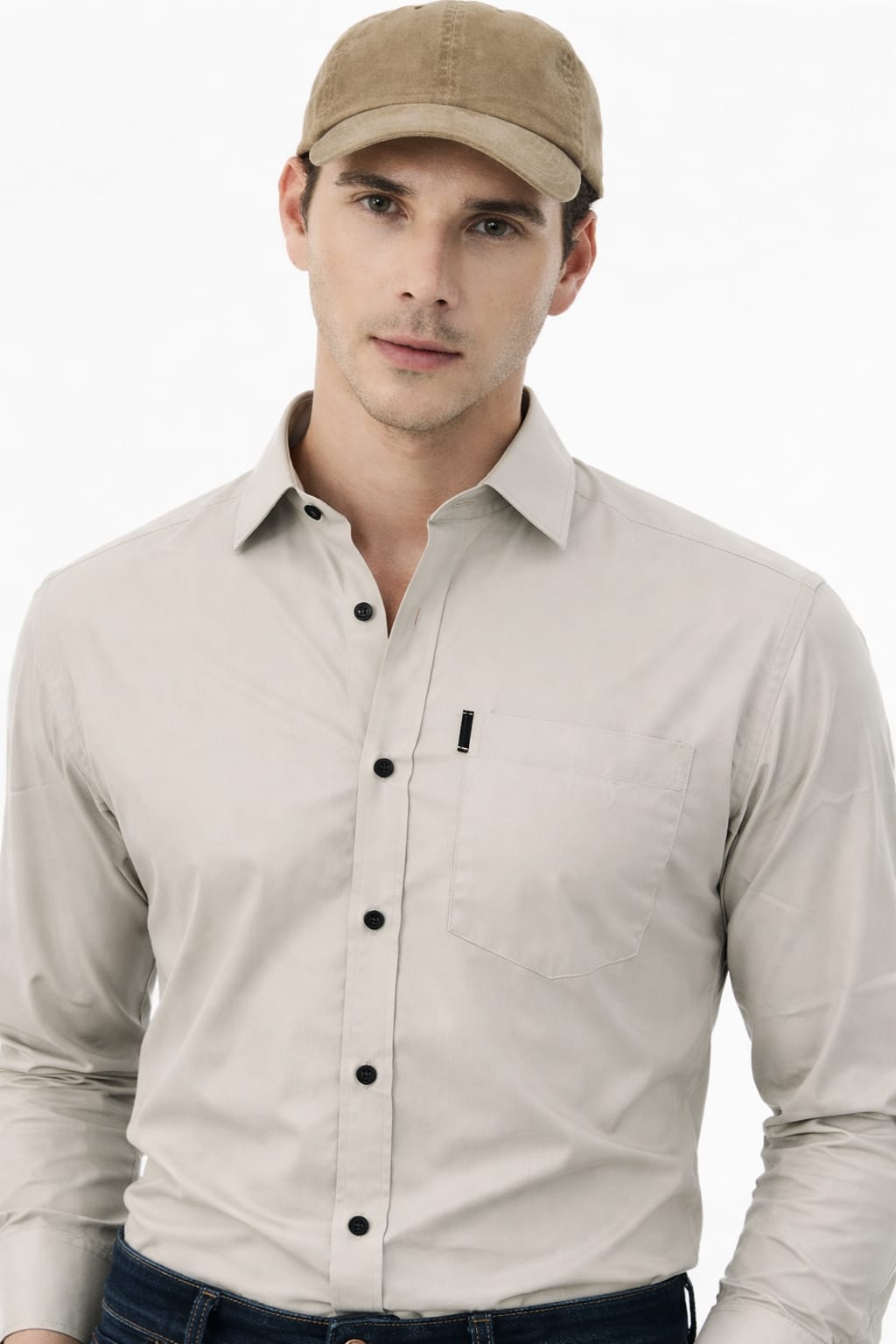 Man wearing a beige shirt with black buttons and a matching cap on a white background