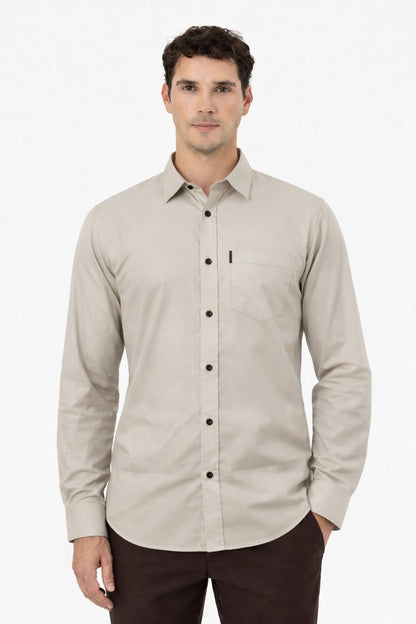 Man wearing a beige button-up shirt on a white background